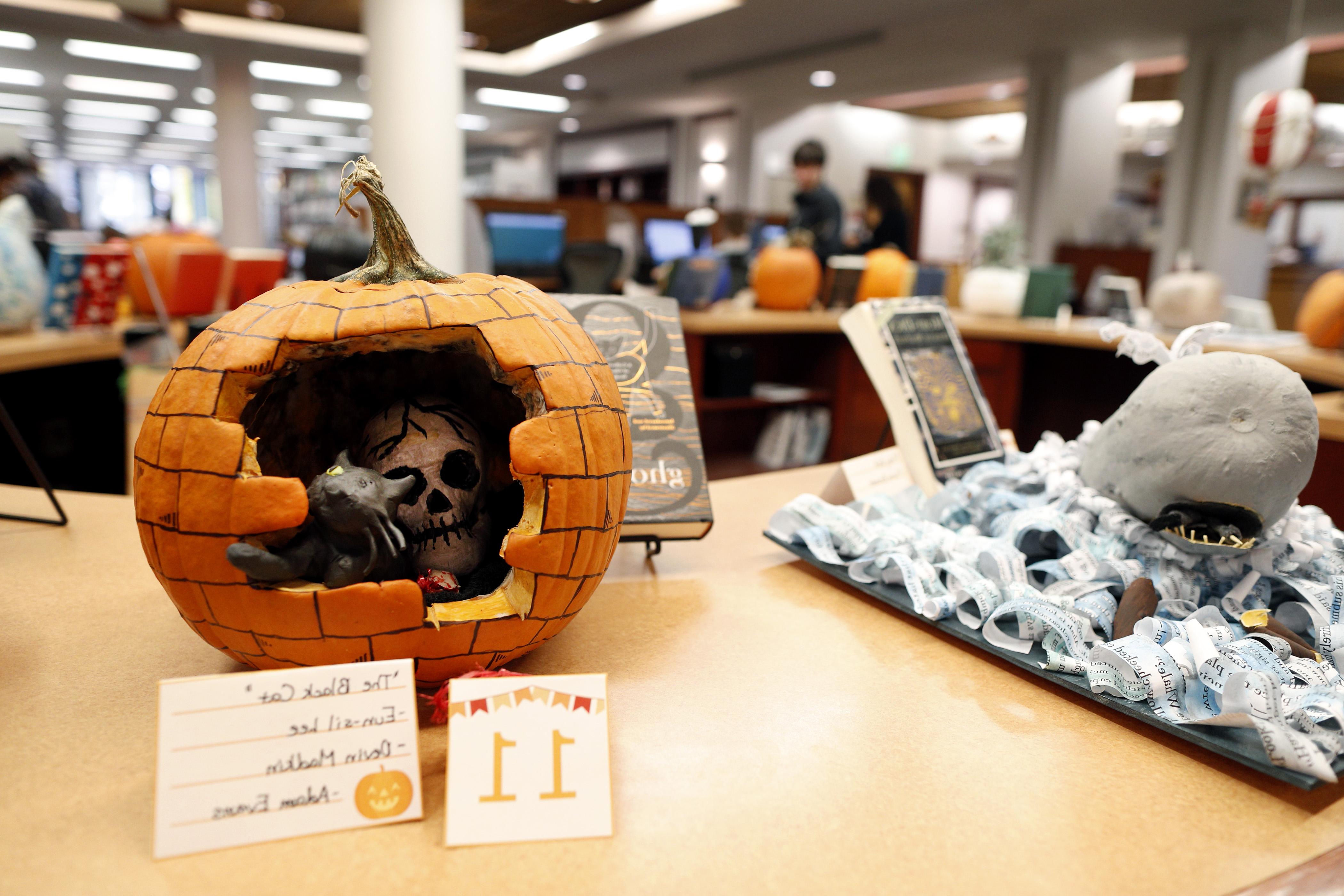 A pumpkin based of Poe's "The Black Cat" sits on a table at Lucy Scribner Library's yearly Great Pumpkin Challenge